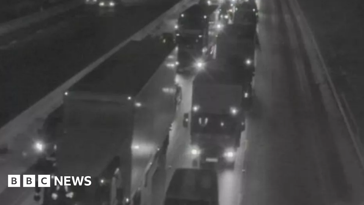 The lights of lorries show up in the dark with traffic at a standstill on the M6 southbound