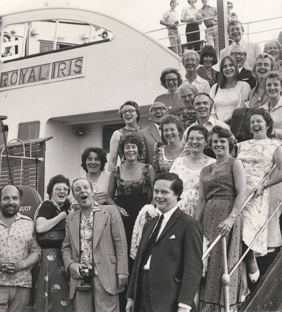 Members of the Liverpool Philharmonic Society get together for a sing-song before the start of a cruise down the Mersey on board the Royal Iris on July 6, 1976. 