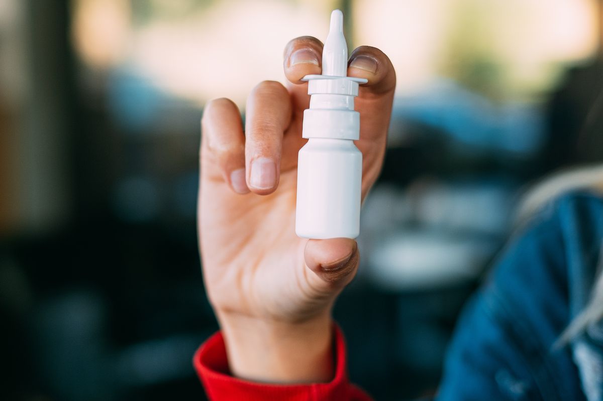 Young Woman Holding Nasal Spray