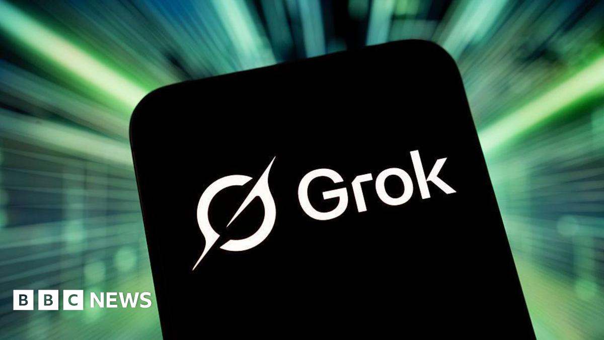 A phone with a black background and the white Grok logo on it. It is against a bright green background.
