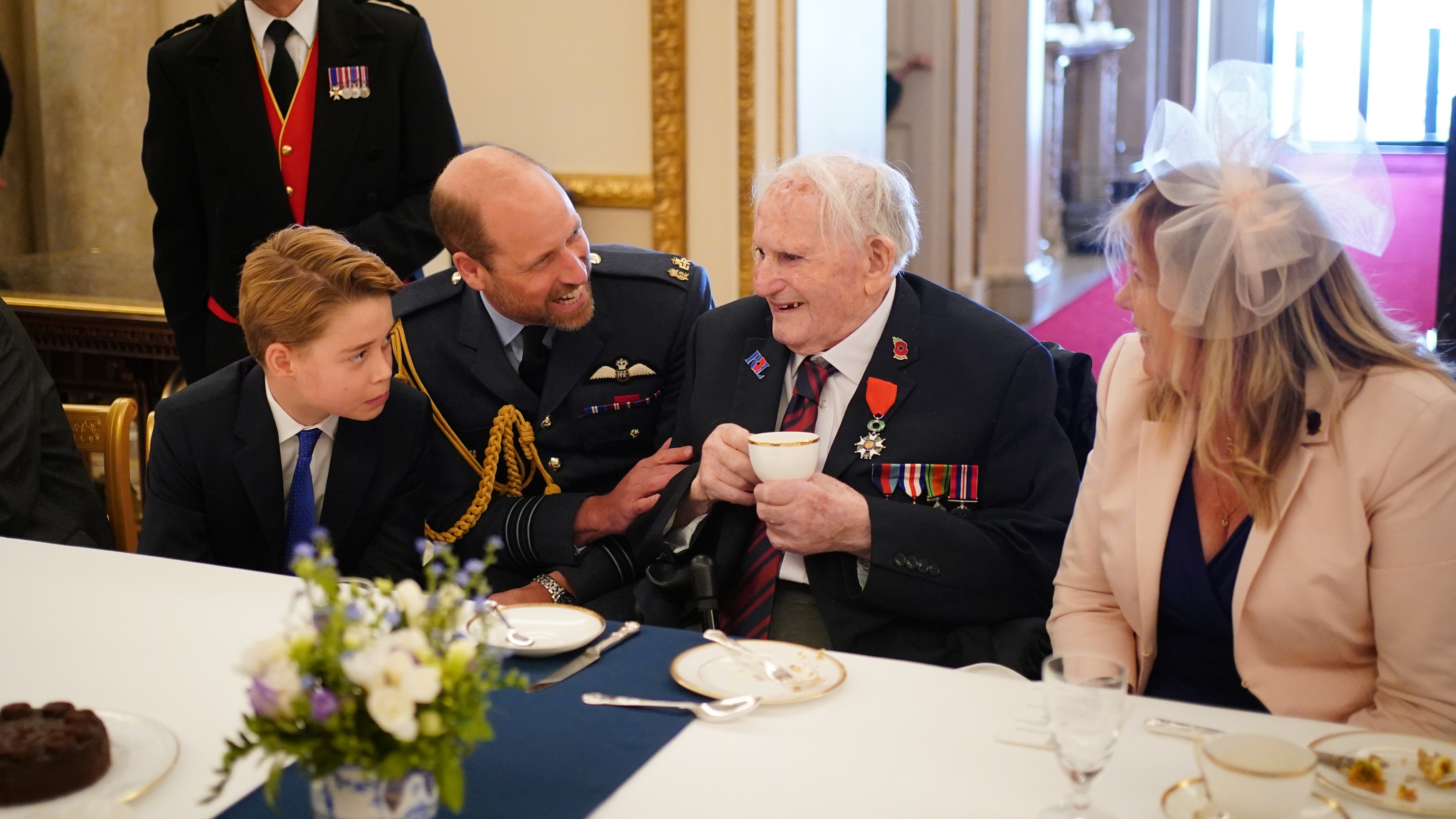 Prince George of Wales and Prince William, Prince of Wales speak with Second World War veterans at a tea party in Buckingham Palace on May 5, 2025
