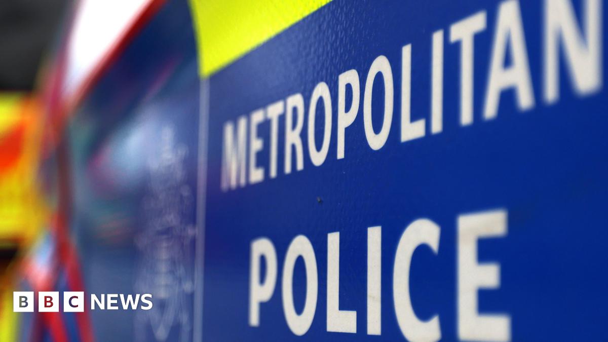 A white and blue sign reading Metropolitan Police.