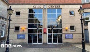 The front entrance to the Civic Centre in Stoke-on-Trent. The two sets of front doors and windows are made up of panels of grass. The words "civic centre" are above the entrance.