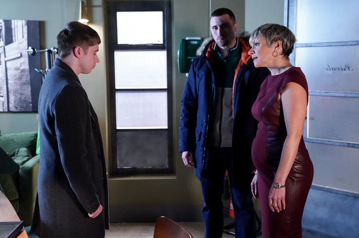 547068,TITLE:Eastenders Barney stands opposite Nicola and Harry in a room in the club in a scene from EastEnders