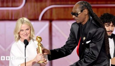 Host Nikki Glaser wears a red gown as she speaks onstage during the 83rd Golden Globe Awards at The Beverly Hilton on January 11, 2026 in Beverly Hills, California.