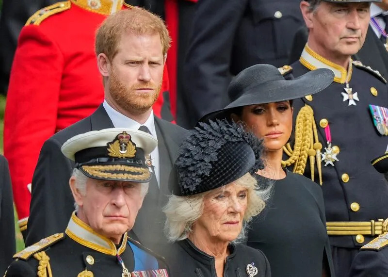 Members of the British royal family watch as the coffin of Queen Elizabeth II is placed into the hearse.