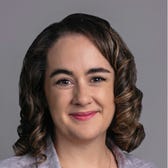 Meghan Morris's face on a gray background