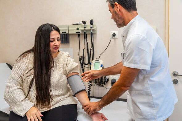Doctor measures patient's blood pressure