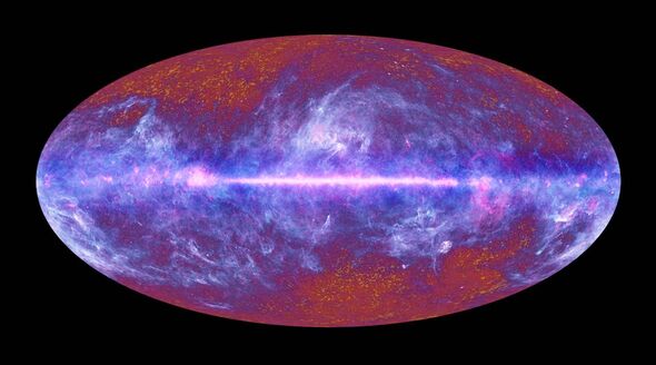 An oval-shaped representation of a cosmic phenomenon, displaying vibrant hues of red, blue, and purple. The image features a cen