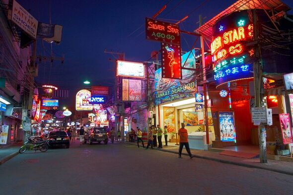An urban street at night, adorned with vibrant neon signs and a lively atmosphere, showcasing the bustling activity of a city's An urban street at night, adorned with vibrant neon signs and a lively atmosphere, showcasing the bustling activity of a city's