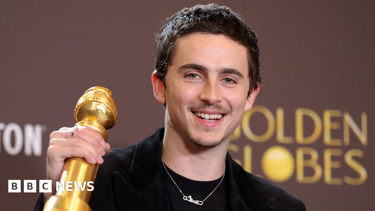 Kylie Jenner and Timothee Chalamet sitting together at dinner table