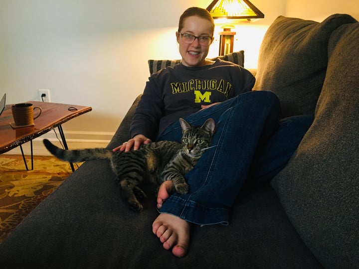The author relaxes with her cat Zooey at home in 2021.