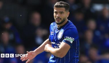 Sam Morsy holding his right arm out with his palm open during a match while playing for Ipswich