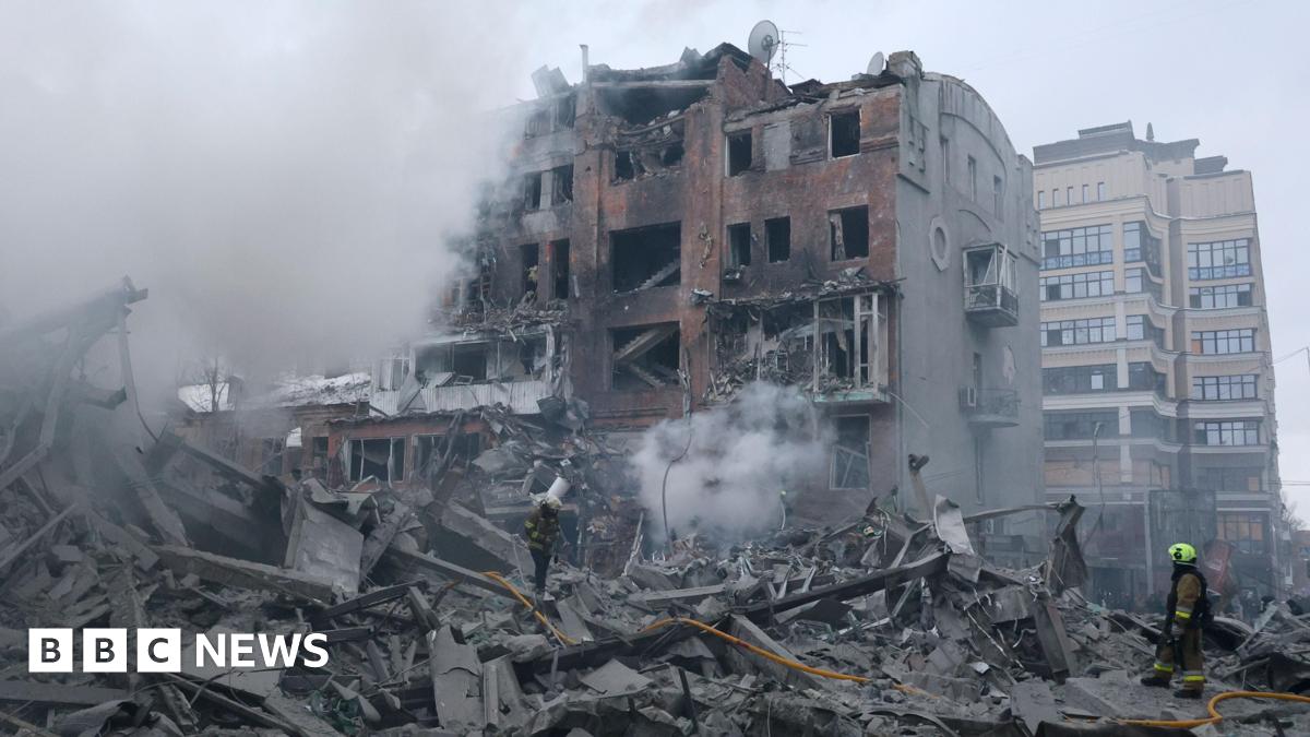 Ukrainian rescuers work at the site of a Russian strike on a residential area in Kharkiv.