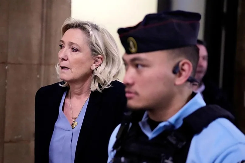 Marine Le Pen leaves the courtroom during a short break in her appeal trial in Paris, Tuesday 20 January 2026