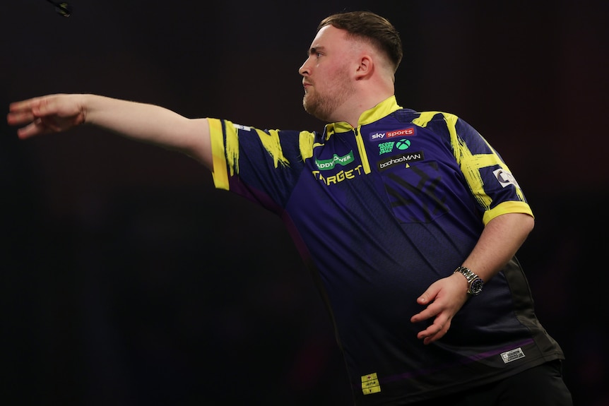 Luke Littler throws a dart during the world championships.