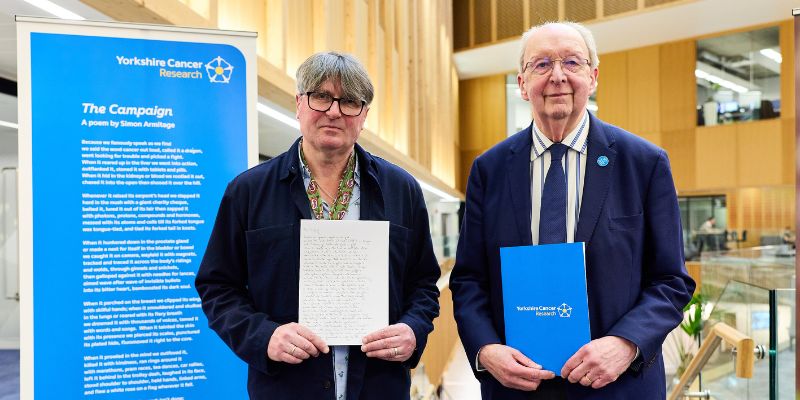 Simon Armitage (left) and Professor Eric Blair (right) smile at the camera.