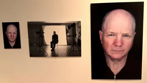 BBC News Three separate shots of Finbar Polin. Two are headshots - he has grey hair and looking intently at the camera. The other is a black and white photo of him sitting on a chair with a camera and light in the foreground, and a white screen behind him.