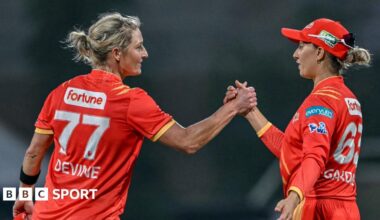 Sophie Devine shales hands with Ash Gardner