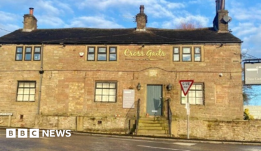 The yellow bricked-front of the Cross Gaits pub, which is on a main road.