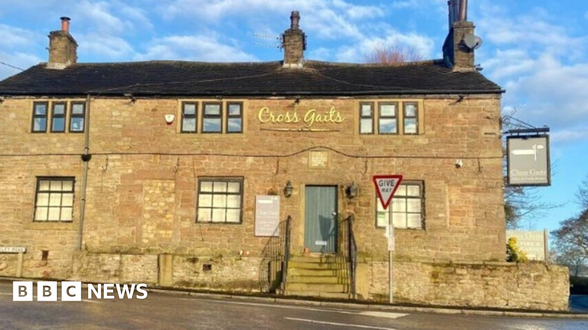 The yellow bricked-front of the Cross Gaits pub, which is on a main road.