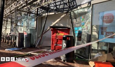 Police tape crosses a pavement outside a shuttered Co-op store, which also has scaffolding around it