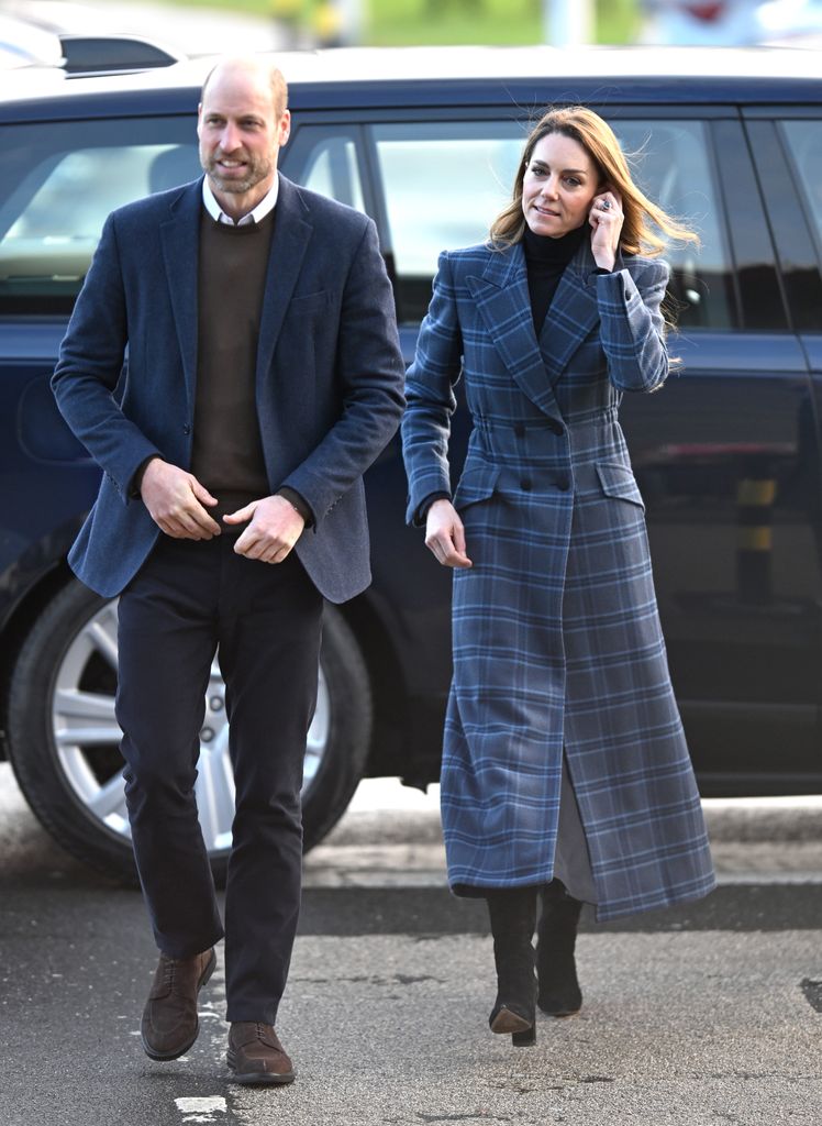 The Princess of Wales in blue tartan coat walking beside william