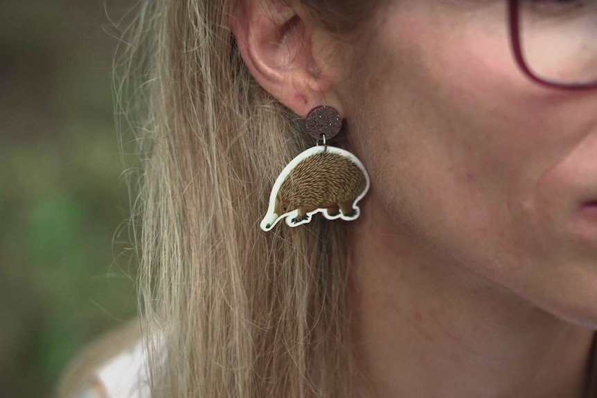 The side of a woman's head showing her wearing an Echidna earing