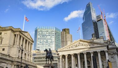 Low angle view of Bank of England, Royal Exchange, and Duke of Wellington equestrian statue (1844) with skyscrapers and construction in background.