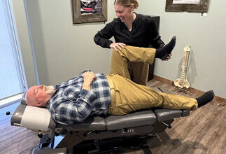 Dr. Emily Hubert working with long-time patient Kevin Konefall. (CNW Group/Chiropractic Association of Alberta)