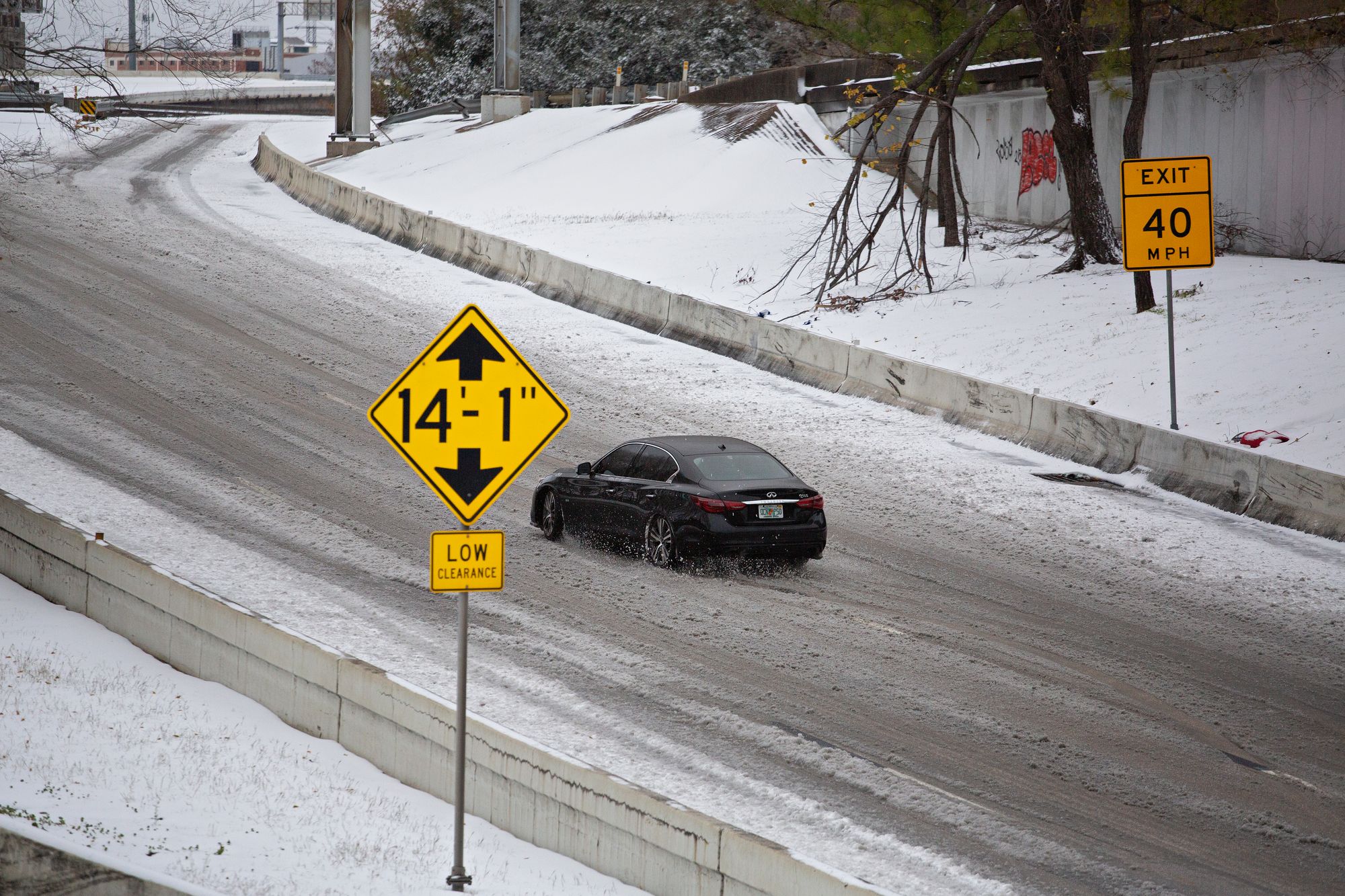 A car drives along a snowy road Houston, Texas, ahead of a winter storm that's expected to hit the state this weekend