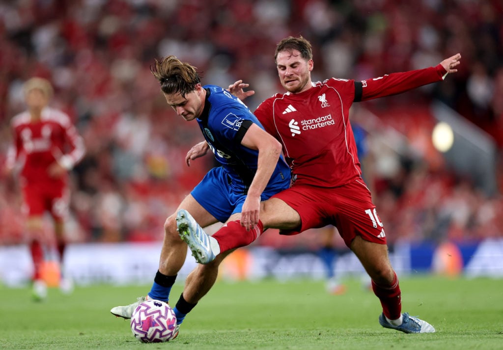Liverpool's Alexis Mac Allister battles Bournemouth's Alex Scott for the ball during the Premier League match at Anfield