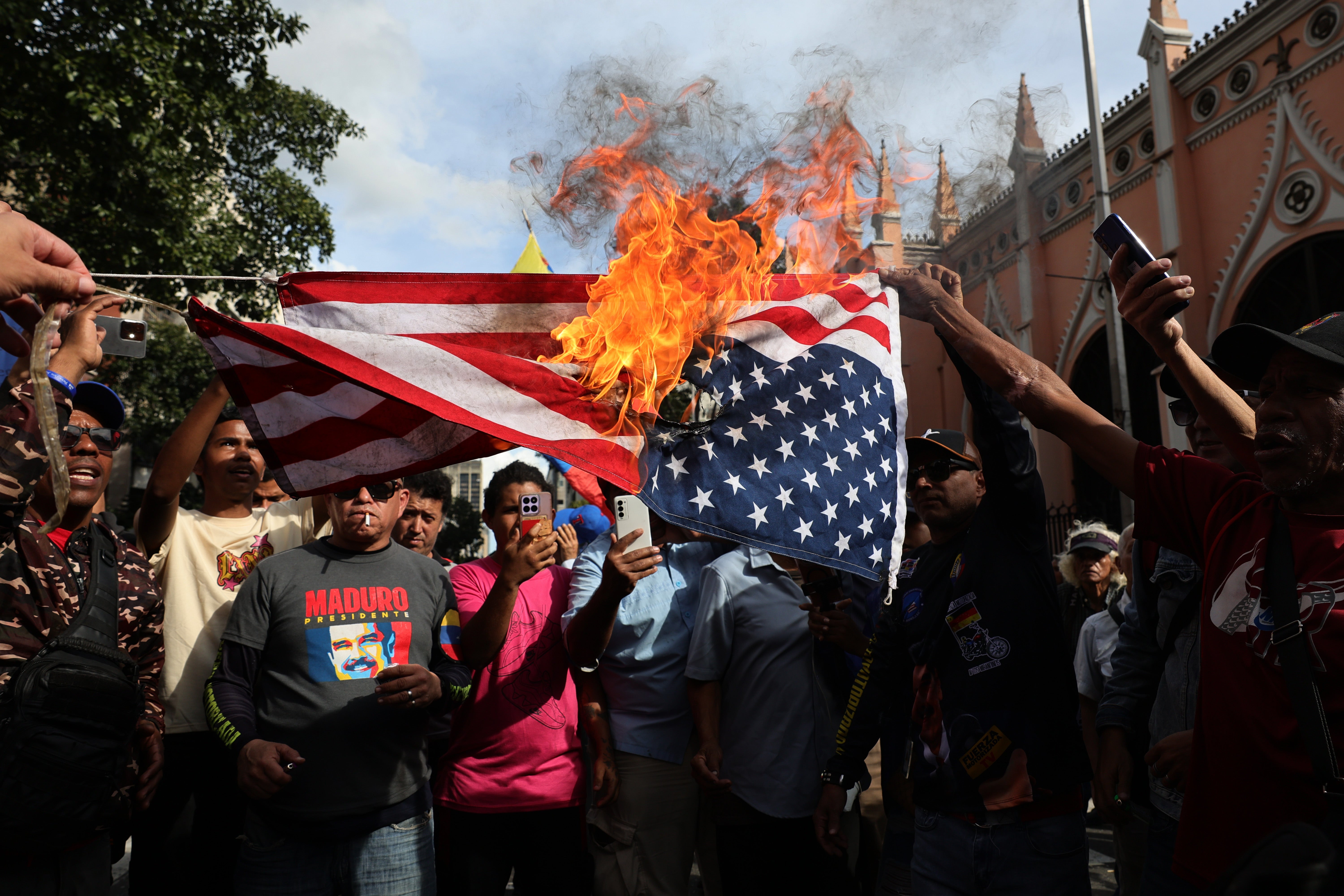 Supporters of Maduro burn a US flag