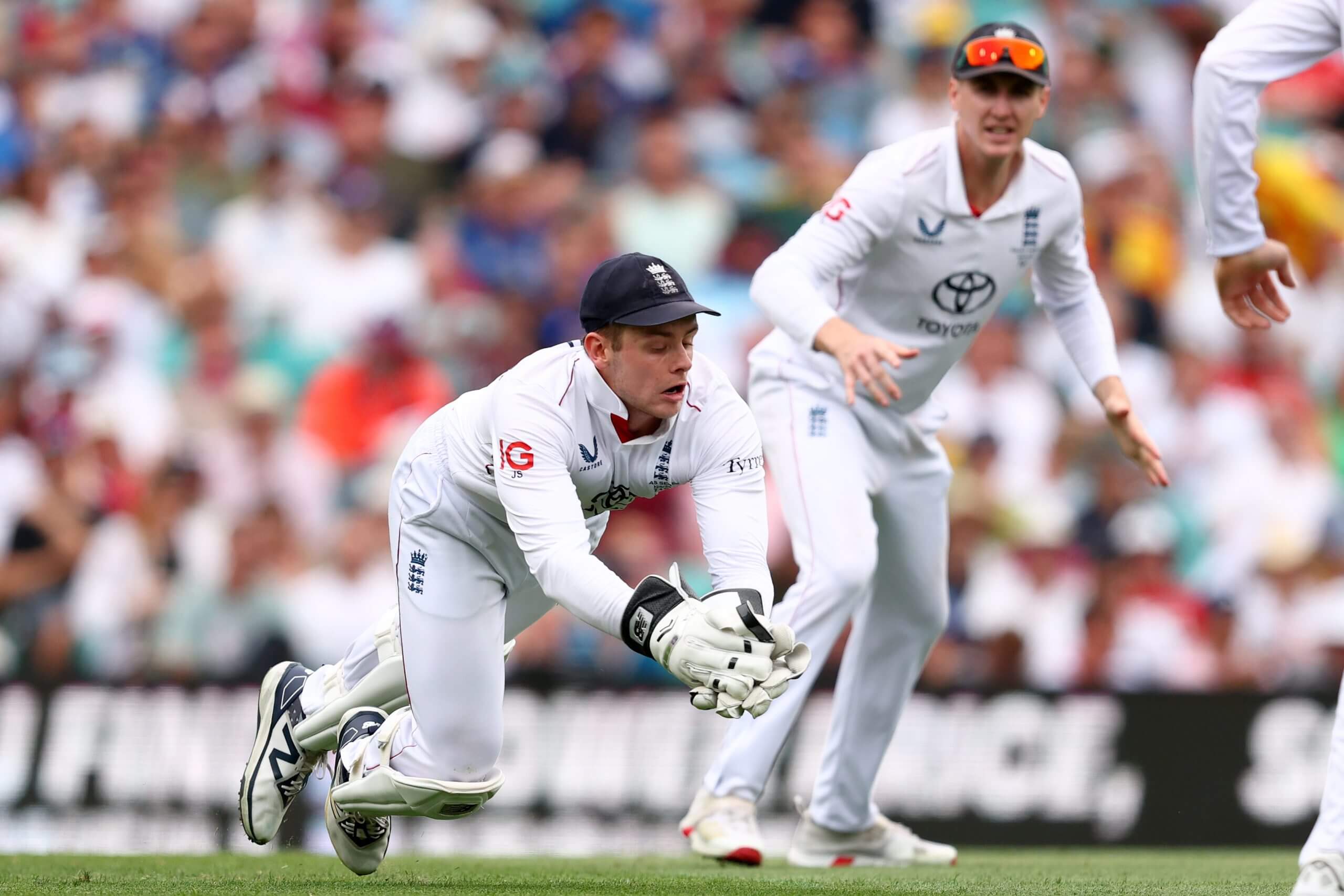 Jamie Smith gathers the ball behind the stumps during Australia's first innings at the SCG