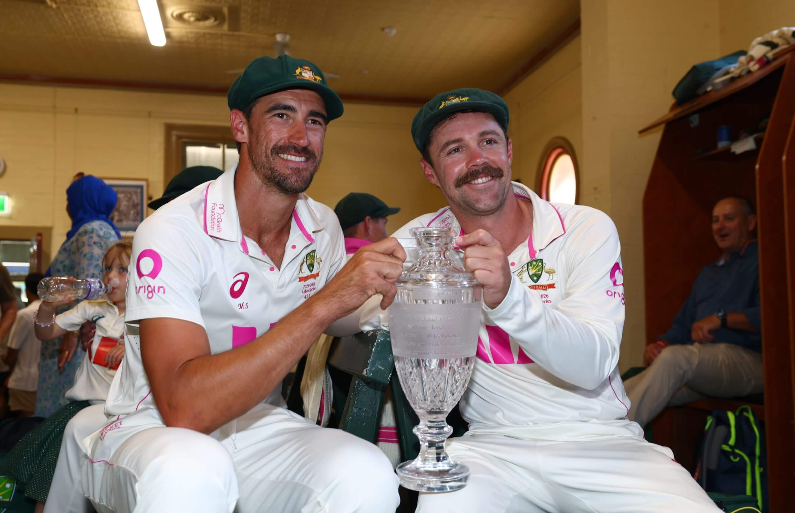 Mitchell Starc and Travis Head pose with the Ashes trophy at the SCG