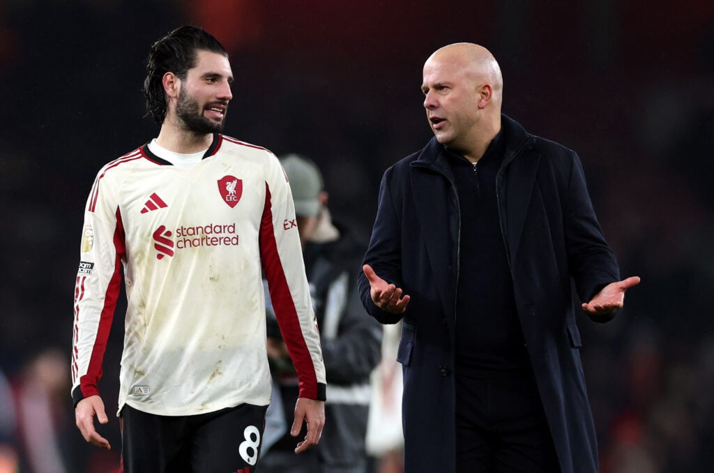 Dominik Szoboszlai and Arne Slot pictured in discussion at the end of Liverpool's Premier League match against Arsenal at the Emirates Stadium.