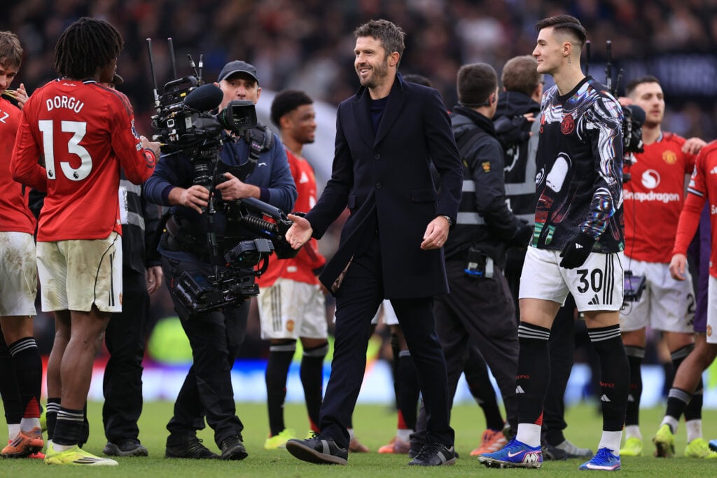 Manchester United interim manager Michael Carrick approaches Patrick Dorgu after the Premier League match between Manchester United and Manchester City at Old Trafford in 2026 in Manchester, England.