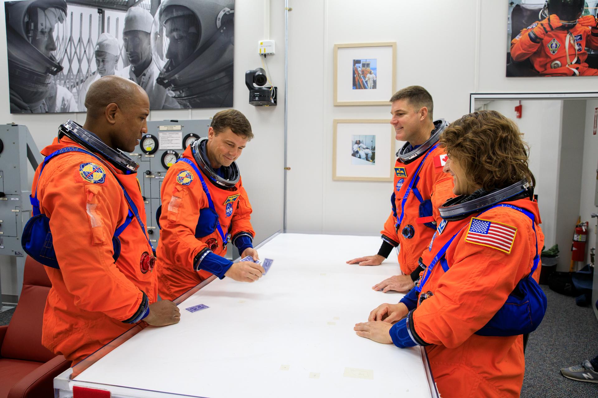 Inside the Astronaut Crew Quarters at the Neil Armstrong Operations and Checkout Building at NASA’s Kennedy Space Center in Florida, Artemis II crew members (from left) NASA astronauts Victor Glover, Reid Wiseman, CSA (Canadian Space Agency) astronaut Jeremy Hansen, and NASA astronaut Christina Koch are shown wearing test versions of the Orion crew survival system spacesuits they will wear on launch day as part of an integrated ground systems test on Wednesday, Sept. 20.