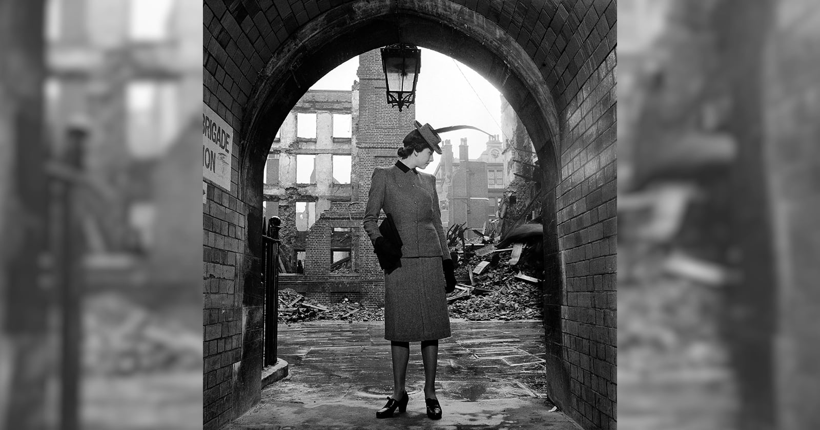 A woman standing in a tunnel.