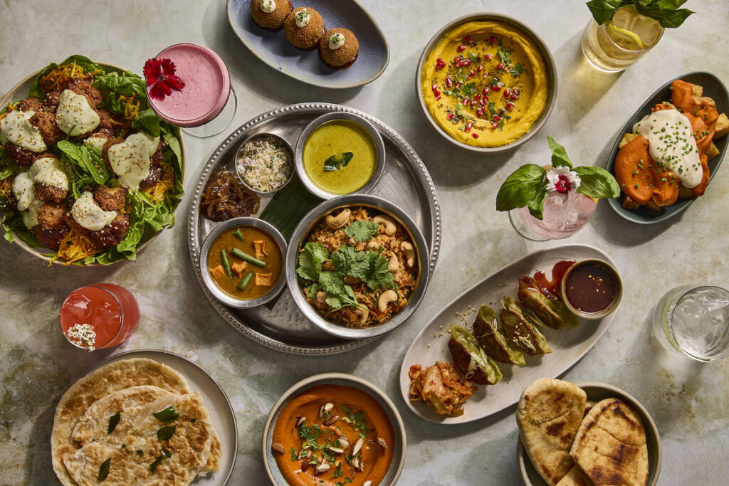 an assortment of colourful vegetarian and vegan dishes presented on a table