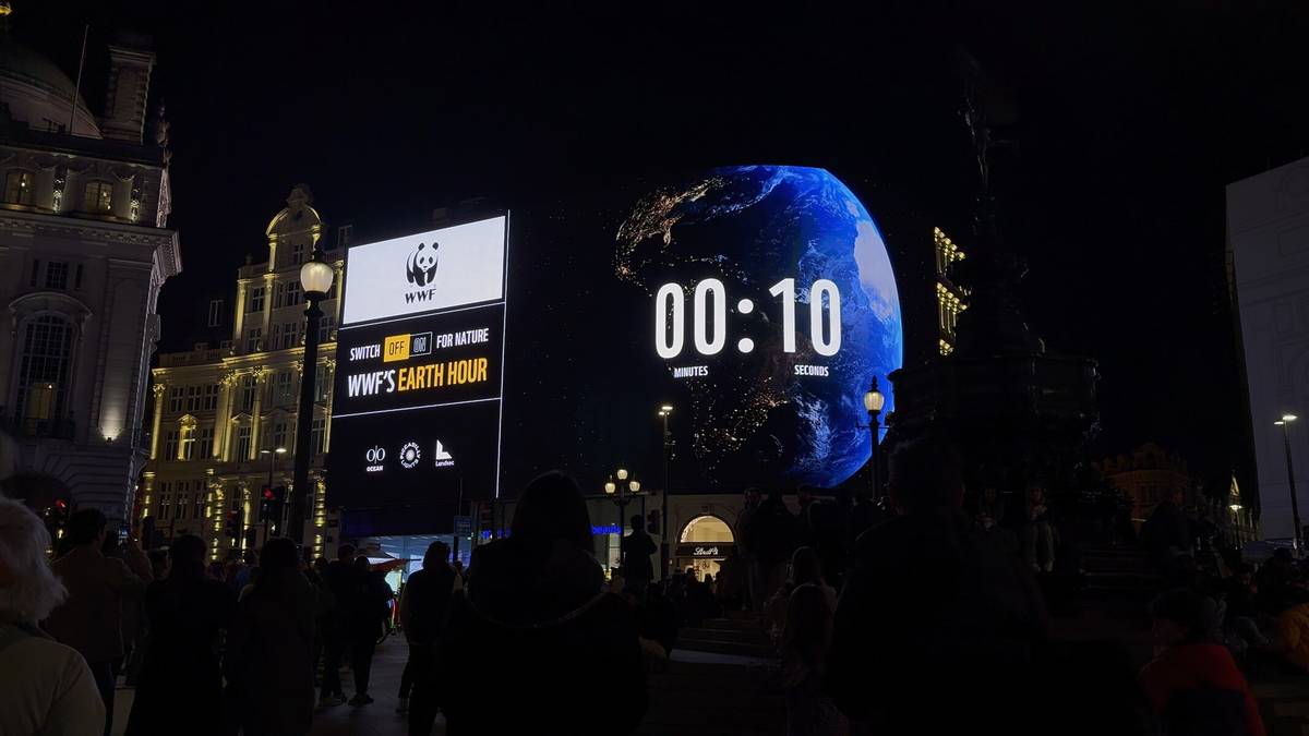 an earth hour countdown clock on a billboard in piccadilly circus