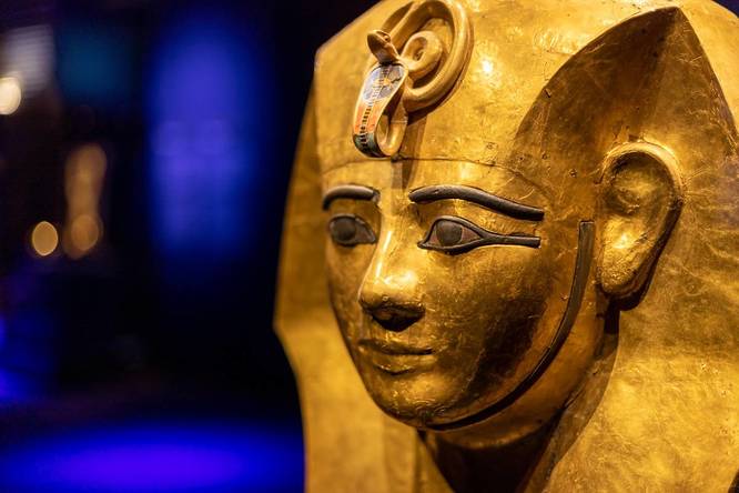 a gold funerary mask of a pharaoh at Ramses and The Pharaohs Gold exhibition