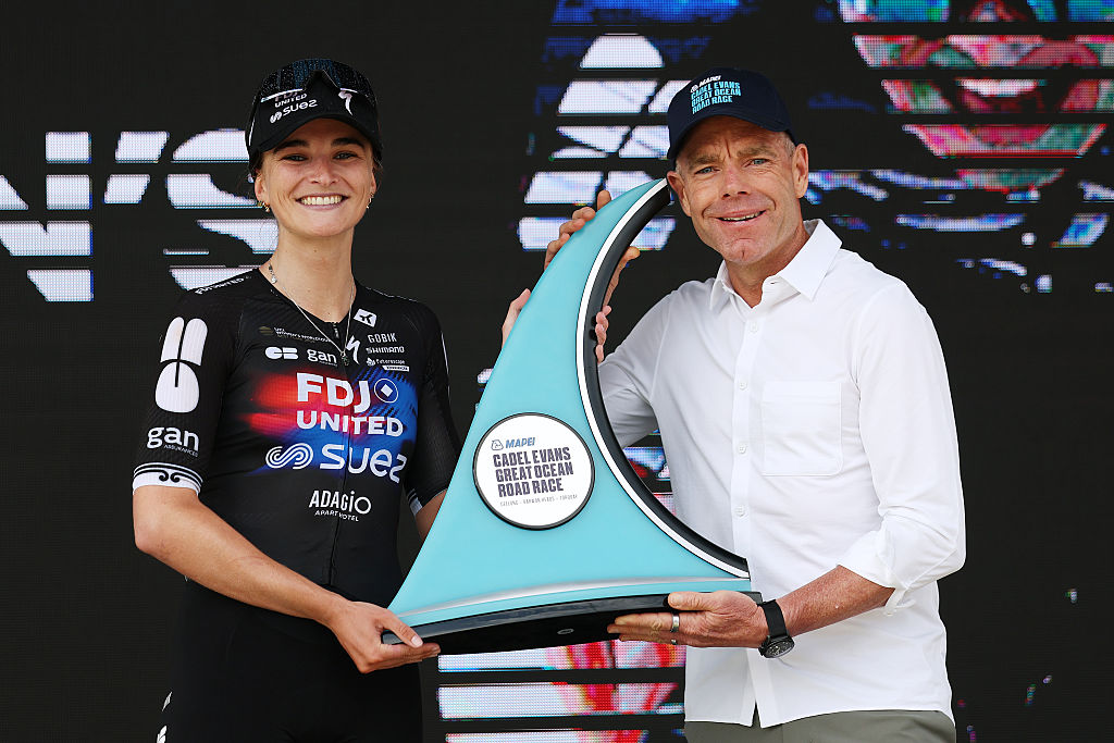 GEELONG, AUSTRALIA - JANUARY 31: Ally Wollaston of New Zealand and Team FDJ United - SUEZ celebrates at podium as race winner with Ex-professional cyclist, Cadel Evans during the 10th Mapei Cadel Evans Great Ocean Road Race 2026, Women&amp;apos;s Elite a 141.2km one day race from Geelong to Geelong / #UCIWWT / on January 31, 2026 in Geelong, Australia. (Photo by Con Chronis/Getty Images)
