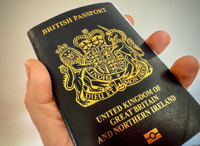 BATH, UNITED KINGDOM - OCTOBER 26: A man holds a post-Brexit United Kingdom issued passport on October 26, 2023 near Bath, England. Since leaving the European Union, the British passport is now a non-EU passport with a blue cover and a gold Royal crest. (Photo by Matt Cardy/Getty Images)