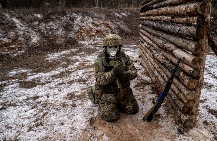 UKRAINE - JANUARY 21: Ukrainian soldiers from the 28th Infantry Brigade take part in tactical training exercises wearing gas masks in a rural area of Ukraine as the war between Russia and Ukraine continues on January 21, 2025. One day after the inauguration of new President Donald Trump, who promised on the campaign trail to end the Ukrainian war in 24 hours, the training and war continues. (Photo by Jose Colon/Anadolu via Getty Images)