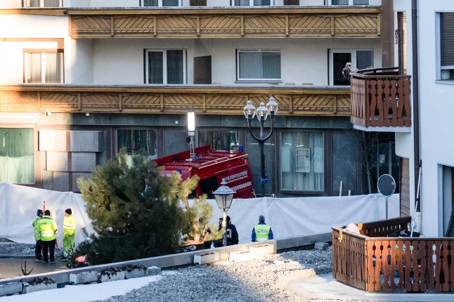 Police officers inspect the area where a fire broke out at the Le Constellation bar and lounge leaving people dead and injured, during New Year???s celebration, in Crans-Montana, Swiss Alps, Switzerland, Thursday, Jan. 1, 2026. (Alessandro della Valle/Keystone via AP)
