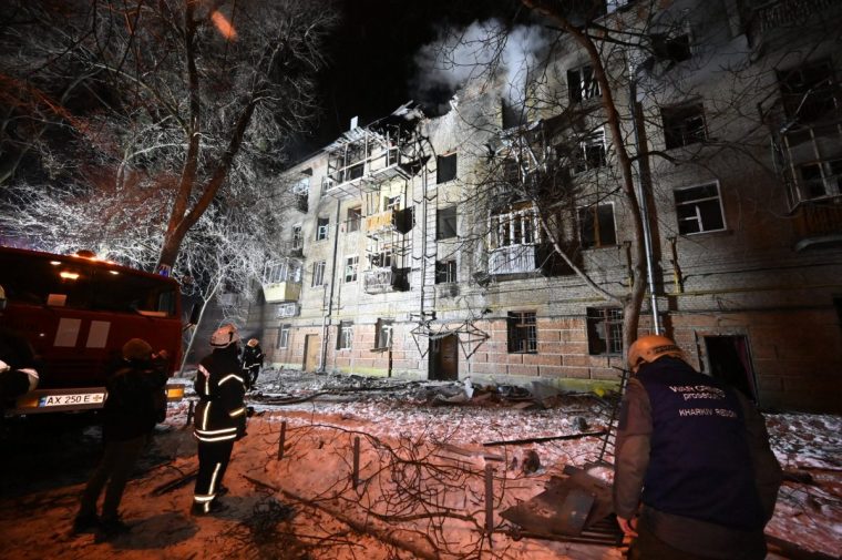 Ukrainian rescuers work at the site of a damaged residential building following an air attack in Kharkiv on January 24, 2026, amid the Russian invasion of Ukraine. Russian strikes killed one person and injured at least 15 others in Ukraine's capital and the northeastern city of Kharkiv overnight, authorities said early on January 24. (Photo by SERGEY BOBOK / AFP via Getty Images)