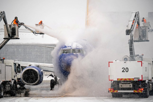A de-icing crew works during winter storm Fern on a Southwest Airlines flight at Nashville International Airport in Nashville, Tennessee, U.S