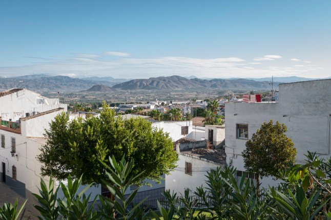 View towards some distant mountains from a high point in a white village.
