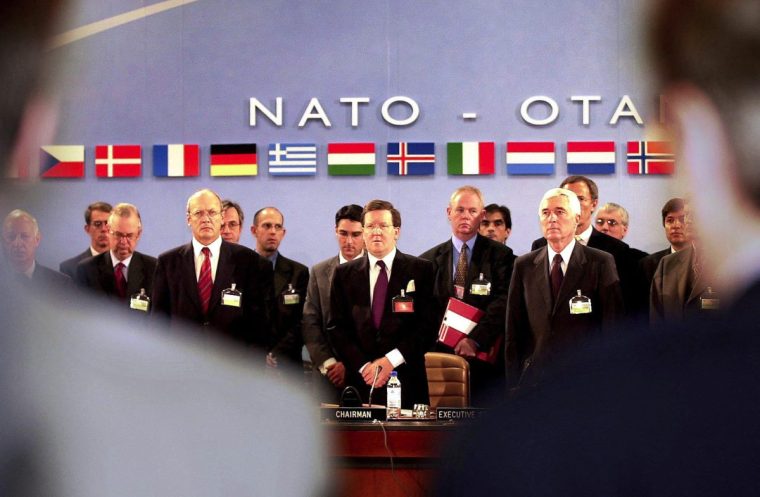 NATO Secretary General Lord George Robertson (C) and the NATO defense ministers observe in Brussels a minute of silence 26 September 2001 to remember the victims of the terror attacks in New York and Washington 11 September. Defense ministers from NATO's 19 member countries will discuss today in Brussels a military response to international terrorism. EPA PHOTO BELGA/OLIVIER HOSLET/win-hh (Photo by OLIVIER HOSLET / BELGA / AFP) (Photo by OLIVIER HOSLET/BELGA/AFP via Getty Images)